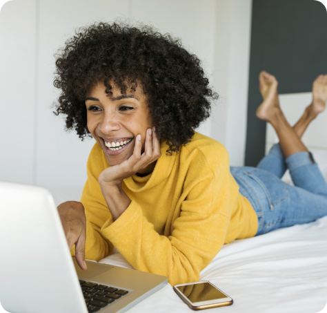 Woman on her laptop, in bed