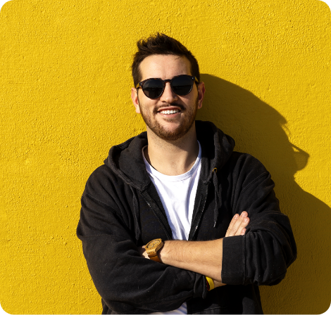 Man leaning against a yellow wall