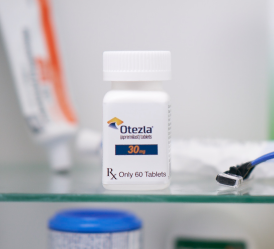 Bottle of Otezla® pills sitting on a bathroom counter